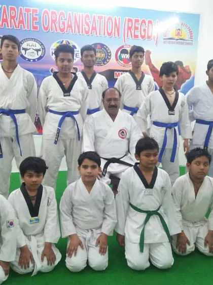 A group of students posing with their instructor after being promoted to their next belt. Belt promotions are important milestones that mark progress and dedication.