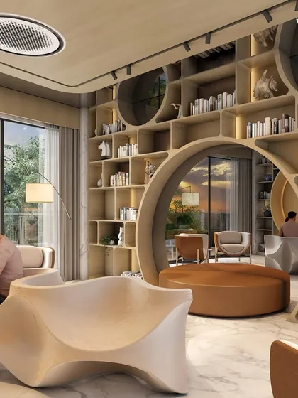 The library at the Alibaug clubhouse, a haven of tranquility. A massive, sculptural bookshelf features a circular reading nook, creating a whimsical and cozy spot for residents to relax with a book.