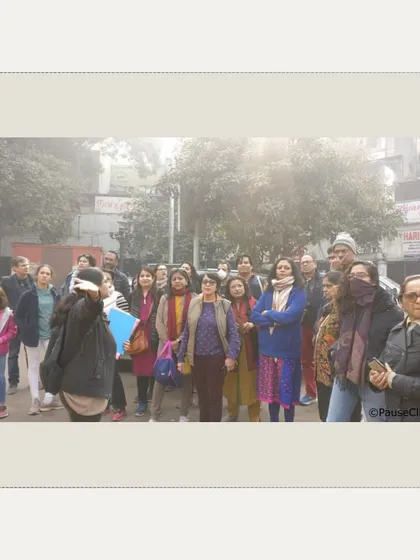 An attentive group listening to the history of the Town Hall and Chandni Chowk. The name 'Chandni Chowk' or 'Moonlit Square' comes from a canal that once reflected the moonlight here.