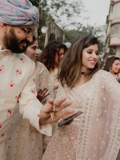 The energy of an Indian baraat is unmatched. Guests dancing on the streets of Mumbai, celebrating the groom's arrival with dhol beats.