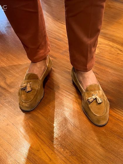 A perfect play of colors. Here, I've paired rich terracotta trousers with tan suede tassel loafers, elevating an office look with a confident use of color.