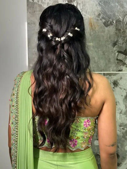 A beautiful half-up hairstyle with soft waves. I added a few shimmering, flower-shaped clips to this bridesmaid's hair for a subtle touch of sparkle.