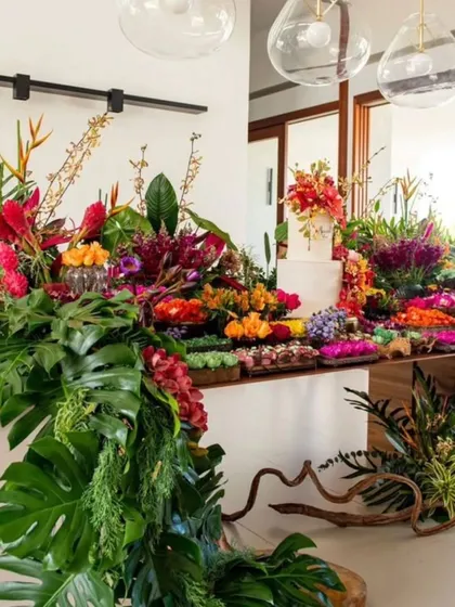 Let us bring a burst of life to your party. This tropical-themed table is overflowing with vibrant, exotic flowers and lush monstera leaves, creating a stunning and festive display for any celebration.