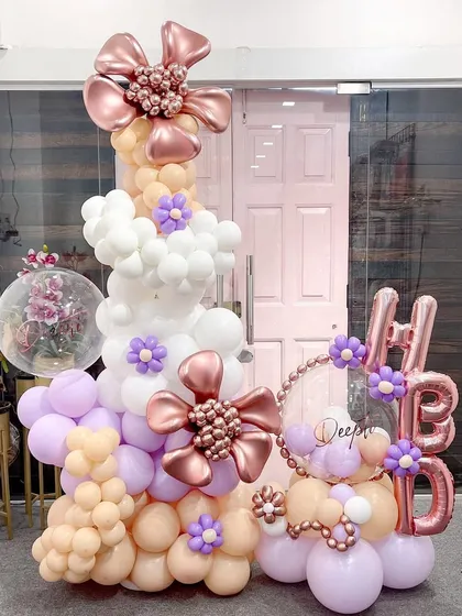 This organic balloon column is a feast for the eyes. The flowing design in pastel peach, lavender, and white is accented with my signature rose gold balloon flowers, making it a perfect photo backdrop or entrance display.