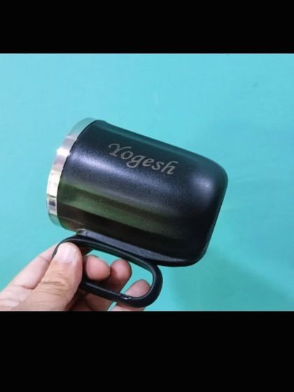 A personalized steel mug with a carabiner-style handle, engraved with the name 'Yogesh'.