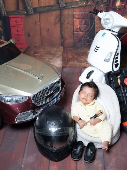 A wider view of the 'Rider' theme, showing the collection of vehicles and tools. This newborn photoshoot is perfect for parents who are passionate about bikes and cars.