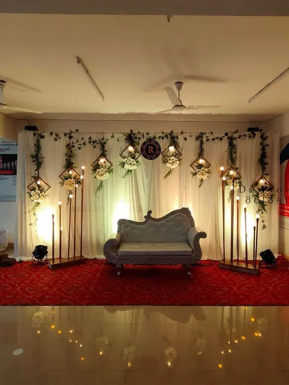 A great photo needs a great setting. This wide shot shows a complete stage decoration for a wedding reception, highlighting the elegant backdrop, seating, and lighting I can help coordinate and capture.