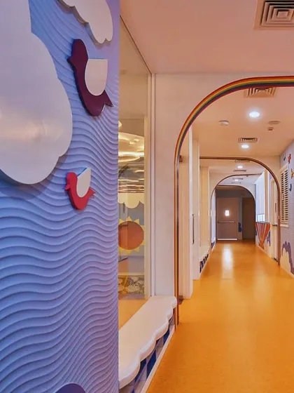 The corridor at Supaksha is an extension of the learning environment, with textured wave walls and colorful flooring. We designed the transitional spaces to be just as engaging as the classrooms themselves.