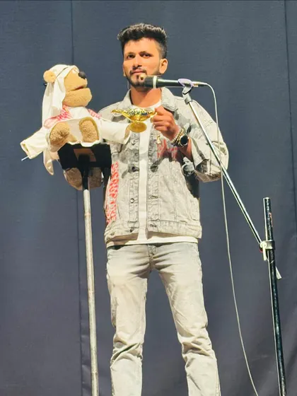 Me on stage with my teddy bear puppet, who plays a Sheikh from Dubai in our act.