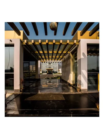 Architectural details like this pergola-covered walkway at the Krishna Sai Granites campus are central to our design approach. It frames the view of the main admin block, creating a dramatic sense of arrival and demonstrating how we integrate landscape and structure.
