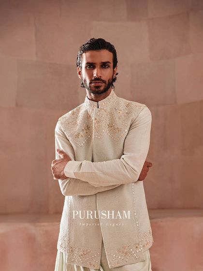 A confident stance in one of my asymmetrical jacket and draped kurta sets. The fine embroidery on the jacket adds a touch of formality, while the silhouette remains modern and fluid.
