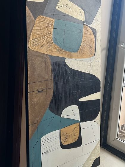The full view of the tall abstract piece, showing its dynamic composition of interlocking shapes in a palette of blue, ochre, black, and white.
