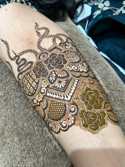 A close up of the forearm, showing the fresh henna paste.