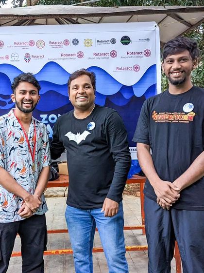 Standing by the event banner with fellow organizers. A lot of work goes into these community events.