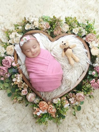 Capturing a sweet, sleepy smile in our floral heart setup. These portraits are a beautiful way to announce the arrival of a baby girl.