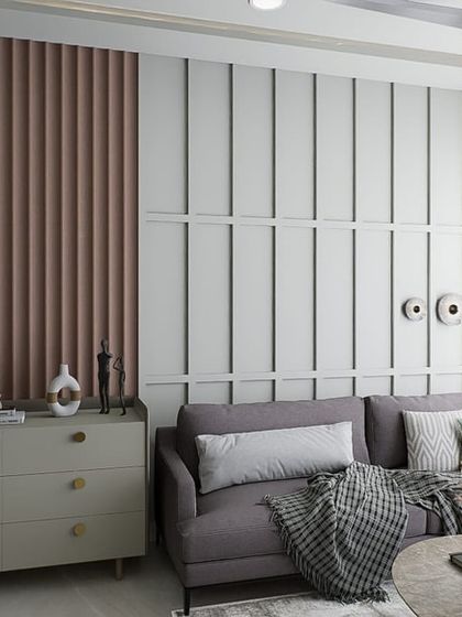 This living room design uses a soft, muted color palette and textured wall panels to create a modern minimalist aesthetic. The space feels calm, clean, and incredibly restful.