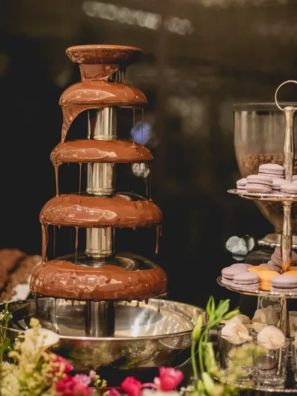 Our dessert displays are designed to be a feast for the senses. A cascading chocolate fountain stands beside a tiered platter of delicate French macarons, promising an indulgent and visually stunning conclusion to your meal.