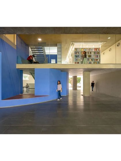 The interior of the School of Arts and Sciences at Ahmedabad University uses bold blocks of color to define different functional zones and create a vibrant, stimulating atmosphere for learning.