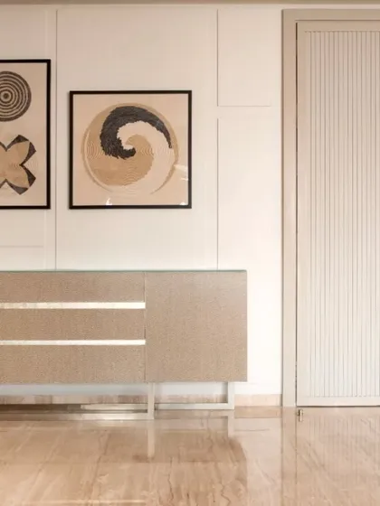 A custom console table with clean lines and metallic inlay, paired with abstract art. This corner demonstrates how I use curated furniture and art to create points of interest in a room.
