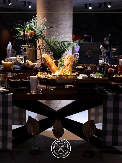 A rustic yet elegant buffet table with a checkered runner and a generous spread of food.