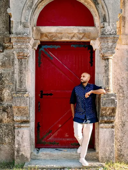 Taking a moment against a classic red door at a castle in Lisbon during a Sangeet night. The venues for destination weddings are always next level, providing an incredible backdrop for the party.
