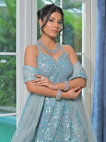 A modern, fashion-forward look featuring a pearl-encrusted gown. The simple diamond drop earrings are the perfect accessory for this statement outfit.