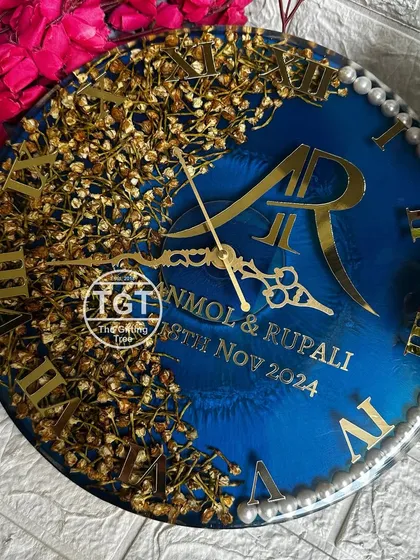 A full-frontal view of the custom clock, clearly showing the couple's monogram, names, and wedding date.