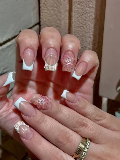 The delicate, translucent petals of the 3D flowers add a touch of elegance and sophistication to these beautiful nail extensions.
