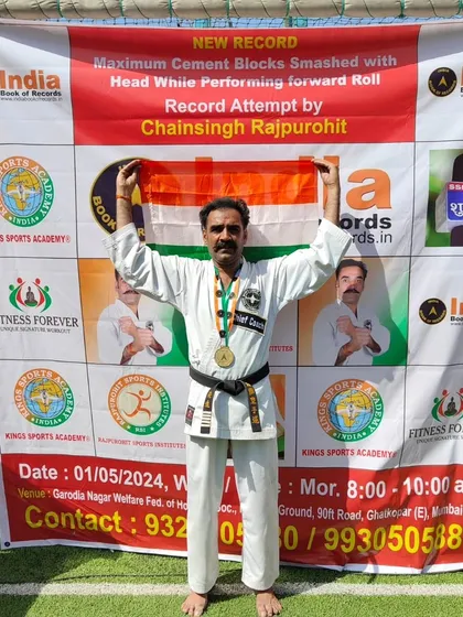 A proud moment for me and for India. Holding our national flag after setting a new world record for smashing 166 cement blocks with my head while performing forward rolls. Jai Hind.