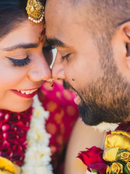 A close-up of Pragya and Srinivas, nose to nose, sharing a sweet, intimate moment during their South Indian wedding.