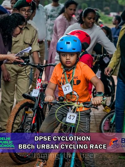 A young rider gets ready at the start, with volunteers and flags creating an official race atmosphere. I strive to give every participant a professional race day experience.
