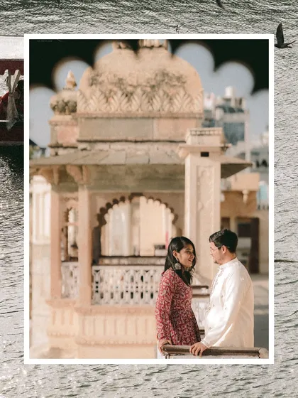 A creative composition framing the couple against the intricate architecture of an Udaipur ghat, with the surrounding water adding texture and depth.