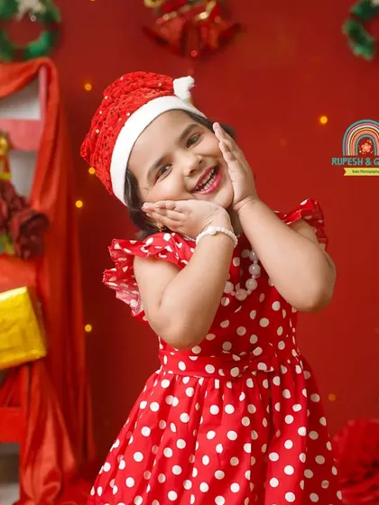 An adorable, cheeky pose from a little girl enjoying her Christmas-themed photoshoot in our studio.