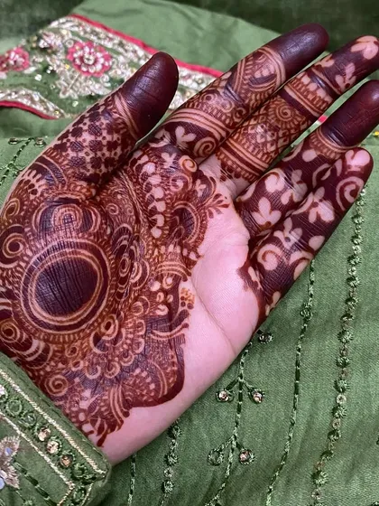 A close-up of a dark stain from a half-hand design, showing the deep color of the central motif.