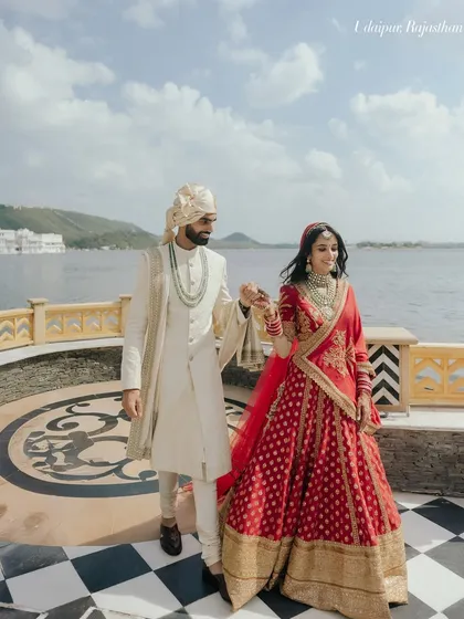 Capturing the grandeur of a royal destination wedding in Udaipur. The majestic backdrop of the lake palace adds a layer of history and romance to this couple's walk into their future.