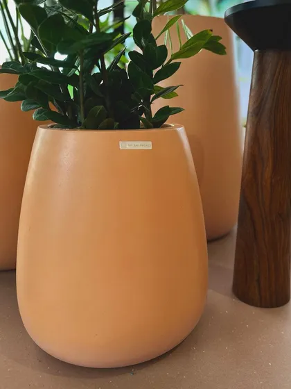 The elegant, curved shape of my modern planter is highlighted in this close-up shot from the client's display.