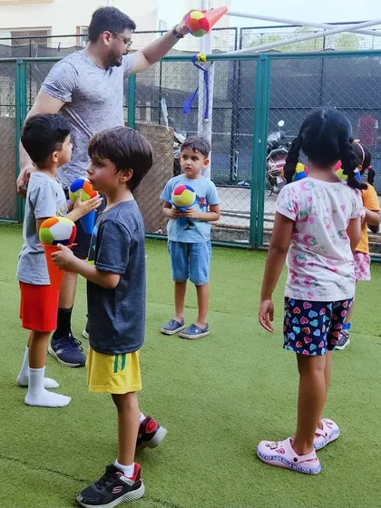 Here I am with one of my groups, getting ready for a ball game. I make sure every session has a low coach-to-child ratio, so I can give each child the attention they need to learn, play, and feel included in the fun.