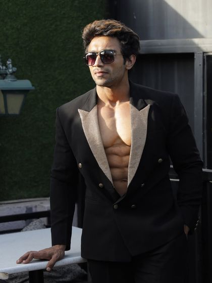 A throwback photo. Showing a lean physique in a stylish suit.