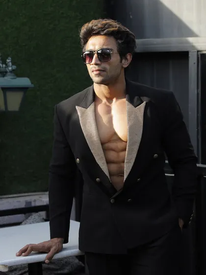 A throwback photo. Showing a lean physique in a stylish suit.