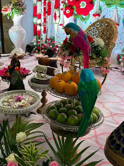 A detailed view of the offering table, showing the variety of fruits and props used.