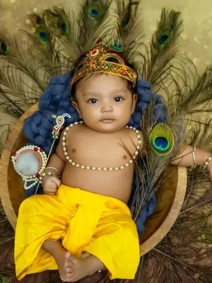 This little one is ready for Janmashtami, holding his props and looking so divine in his Krishna costume.