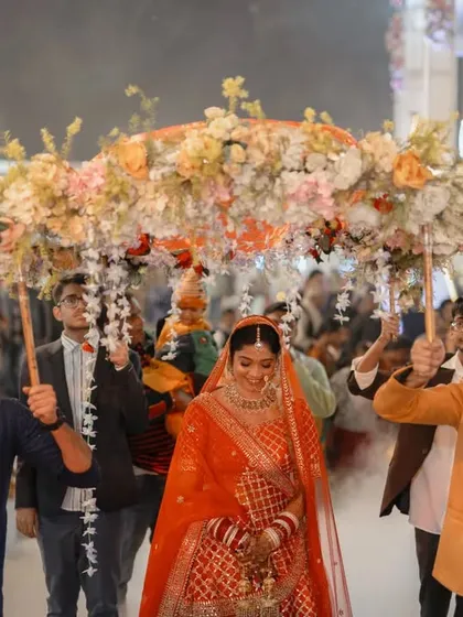 The bridal entry is a moment of pure magic, a scene straight out of a film. Escorted by her loved ones under a canopy of flowers, the bride walks towards her future. I focus on capturing the grandeur of the moment, the look of awe on everyone's faces, and the bride's own mix of excitement and emotion.