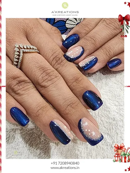A winter wonderland on your fingertips. This holiday design features a deep, starry blue polish combined with a sheer glitter base and delicate, hand-painted white starbursts.