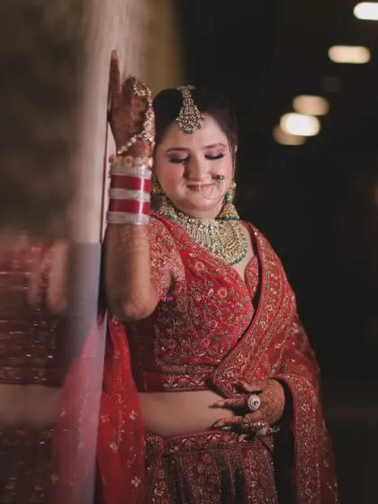 A beautiful bridal portrait of the bride smiling, captured in the warm, soft light of the wedding venue. This photo radiates happiness and the excitement of the big day.