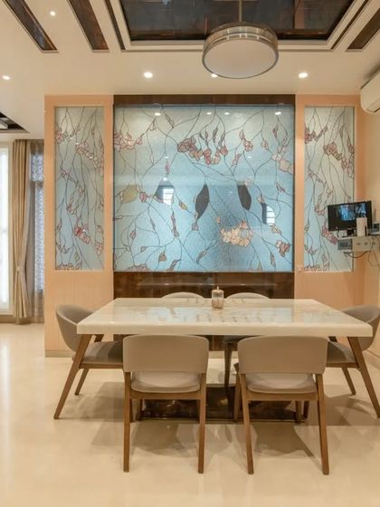 The dining area is defined by a beautiful stained-glass partition, adding color and artistry to the space.