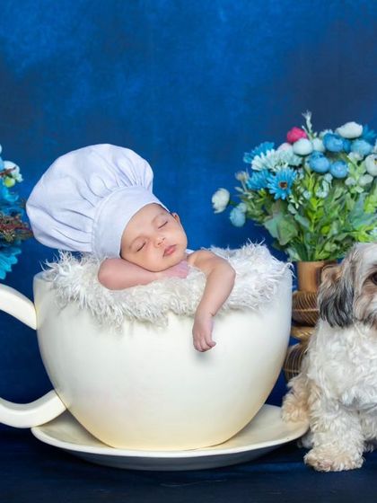 This version of the teacup chef includes a cute puppy, adding another layer of sweetness to the photo.