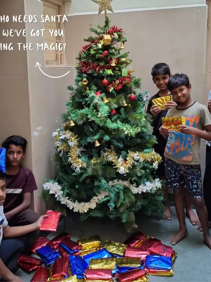 Who needs Santa when we've got you bringing the magic? Children at one of our libraries stand by a Christmas tree surrounded by gifts, a beautiful sight made possible by our generous donors.
