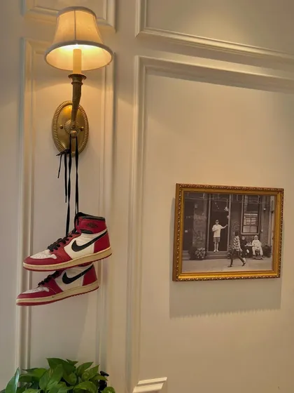 An artistic shot of my Air Jordan 1s hanging from a lamp. Street culture and style are a big part of my identity and influence both my music and my design work.