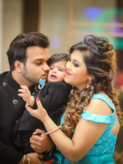 A candid moment of love, with mom and dad kissing their little one. These are the emotional, unscripted shots that truly tell your family's story.