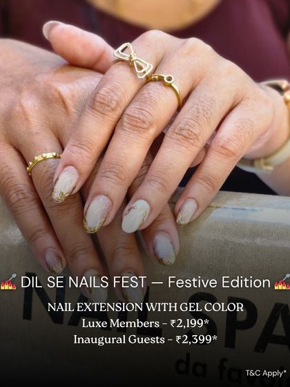 An elegant set of nail extensions with a soft, marbled design and gold foil accents. This look is perfect for a special occasion, offering both length and sophisticated artistry.